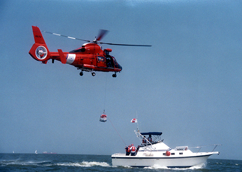 U.S. Coast Guard helicopter hovering over an enforcement boat